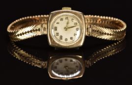 English 9ct gold ladies wristwatch with gold hands and Arabic numerals, silver dial and 15 jewel
