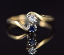 A 9ct ring set with a diamond and sapphire in twist setting, 2.2g, size O
