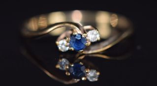 A 9ct gold ring set with a sapphire and diamonds, 1g, size M