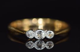 An 18ct gold ring set with three diamonds in a platinum setting, 2.3g, size P