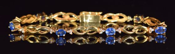 An 18ct gold bracelet set with six oval cut sapphires measuring approximately 0.4ct each and