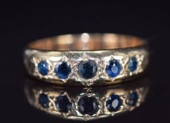 A 9ct gold ring set with five sapphires in star settings, 2.8g, size L/M