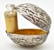 Novelty silver scent bottle holder formed as a walnut, hinging open to reveal a hinge out bottle