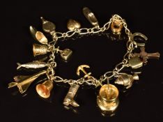 A 9ct gold charm bracelet with fifteen 9ct gold charms including Concorde, fish, bell, shoe,