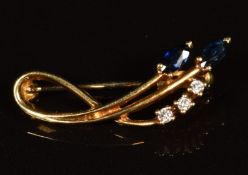 An 18ct gold brooch set with two marquise cut sapphires and diamonds, 3.3g
