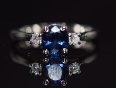 A platinum ring set with a 1.43ct oval cut sapphire and two diamonds, 4.4g, size M