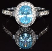 An 18k white gold ring set with an oval cut treated quartz and diamonds, 4.9g, size M