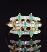 An 18k gold ring set with six marquise cut emeralds and diamonds (one emerald missing), 5.1g, size