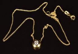 An 18ct gold pendant set with a round cut diamond of approximately 0.25ct, on an 18ct gold chain,