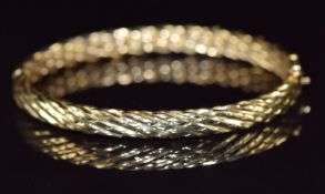 A 14k gold bangle with twist design, 16.7g