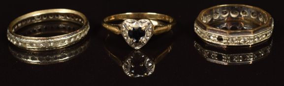 A 9ct gold ring set with a sapphire and diamonds in a heart shaped setting and two 9ct gold eternity