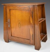 Arts & Crafts oak smoker's cabinet with exterior pipe racks to the sides, fitted interior and