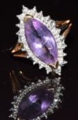 A 9ct gold ring set with a marquise cut amethyst surrounded by diamonds, 3.2g, size K