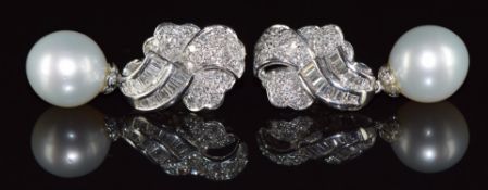 A pair of 18ct white gold earrings set with round and baguette cut diamonds totalling 1.83ct and