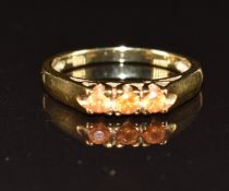 A 9ct gold ring set with three orange sapphires, 2.4g, size N