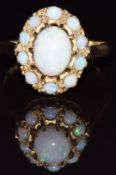 A 9ct gold ring set with opals, 2.4g, size M