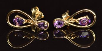 A pair of 9ct gold earrings set with amethysts, 1.2g