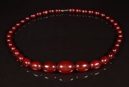 A cherry amber necklace made up of 39 oval beads, the largest 19 x 13mm, 22g