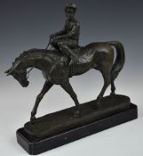 Bronze jockey on horseback, marked to base Coreita, on black marble plinth, length 30cm
