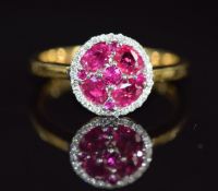 An 18ct gold ring set with rubies and diamonds in a cluster, 4.2g, size O