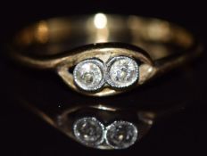 An 18ct gold ring set with two diamonds in a platinum twist setting, 2.3g, size N/O