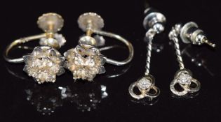 A pair of 9ct white gold earrings set with diamonds and a pair of white metal earrings set with