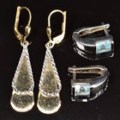 A pair of 14k white gold earrings each set with a topaz and a pair of 14k gold bi-coloured earrings,