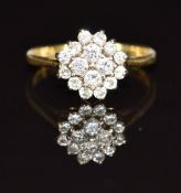 An 18ct gold ring set with diamonds in a cluster, 2.3g, size G/H