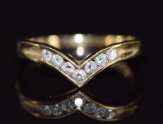 A 9k gold V shaped ring set with seven diamonds, 2.2g, size P