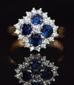 An 18ct gold ring set with four sapphires each approximately 0.2ct and diamonds, 5.5g, size M