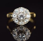 An 18ct gold ring set with diamonds in a cluster, the centre diamond approximately 0.52ct, 5.5g,