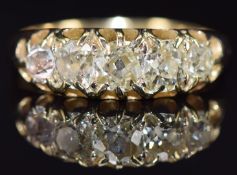 An 18ct gold ring set with five old mine cut diamonds, the centre diamond approximately 0.35ct, 3.