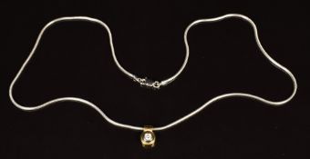 An 18ct white gold snake chain and an 18k gold pendant set with a diamond of approximately 0.12ct,