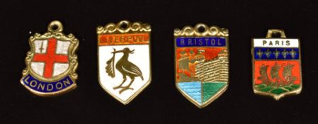 Four 9ct gold shield shaped charms set with enamel including 'Bristol', 'London', 'Liverpool', '