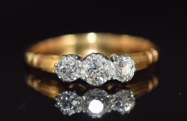 An 18ct gold ring set with three old cut diamonds, the centre diamond approximately 0.35ct, 2.8g,