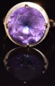 An 18ct gold ring set with a synthetic purple sapphire, 4.4g, size O