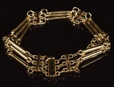 A 9ct gold three stand bracelet made up of elongated and oval links, 22.7g