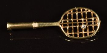 A c1930's 18ct gold brooch in the form of a tennis racquet, set with a transitional cut diamond, 3.