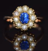 A c1900 9ct gold ring set with an oval cut sapphire surrounded by pearls, 4.1g, size O