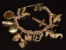 A 9ct gold charm bracelet with ten 9ct gold charms including car, church, seahorse, swivel fob,