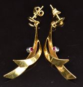 A pair of 18ct gold earrings set with rubies, 4.7g