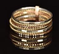 A 9ct gold tri-coloured ring made up of seven faceted and rope twist bands, 3.5g, size M/N