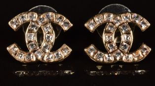 A pair of Chanel earrings in the iconic CC logo set with paste, marked Chanel 16 V to back, in