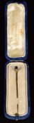 A 9ct gold stick pin set with an oval sapphire (1.4g), in antique box