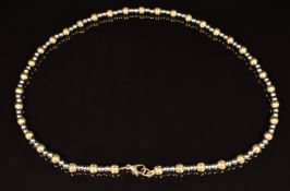 A 9ct gold bi-coloured necklace made up of beads, length 44cm, 16.6g