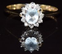 A 9ct gold ring set with aquamarine surrounded by diamonds (missing two diamonds), 1.6g, size M
