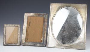 Three hallmarked silver photograph or similar frames including an oval example, Birmingham 1915,