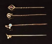 Three 9ct gold stick pins set with zircon, seed pearls and garnet (2.7g) and one other