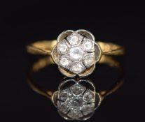 An 18ct gold ring set with with sapphires in a cluster, 1.5g, size L