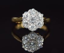 An 18ct gold ring set with seven diamonds in a cluster, the centre diamond approximately 0.25ct, 3.